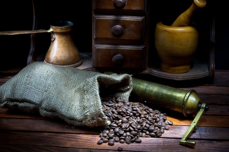 Vintage coffee grinder and cezve with roasted coffee beansの写真素材