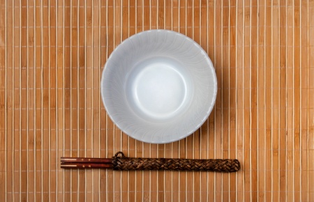 asian style bowl and chopstick on bamboo background.の写真素材