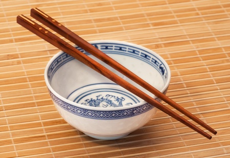 asian style bowl and chopstick on bamboo background.の写真素材