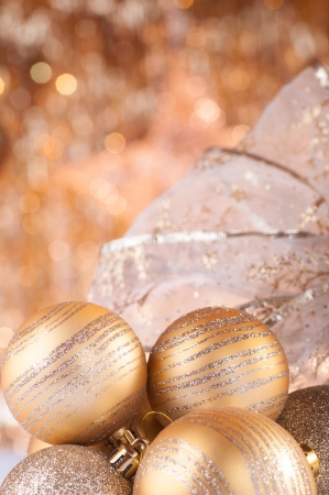 gold christmas baubles on background of defocused golden lights.の写真素材