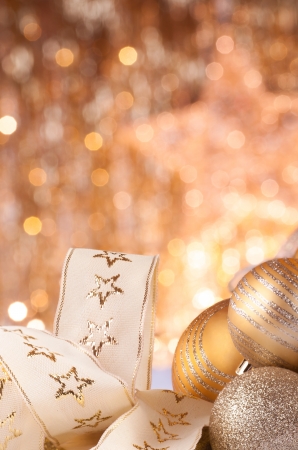 gold christmas baubles on background of defocused golden lights.の写真素材