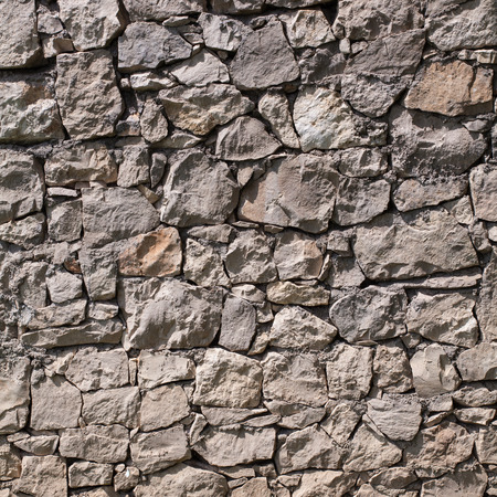 cracked real stone wall , for background or textureの写真素材