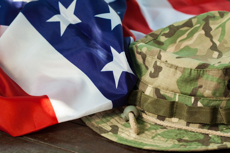 US flag with camouflage cap combat hatの写真素材