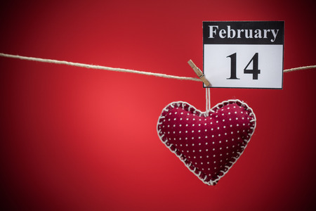 February 14, on the calendar, Valentine's day, red heart, red backgroundの写真素材