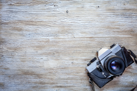Old retro camera on vintage wooden table backgroundの写真素材