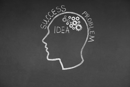 Human head and Gear Wheel idea Concept Drawing on Blackboard Textureの写真素材