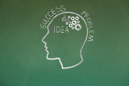 Human head and Gear Wheel idea Concept Drawing on Blackboard Textureの写真素材