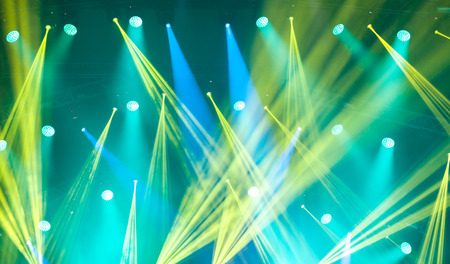 Stage lights on concert. Lighting equipment with multi-colored beams.