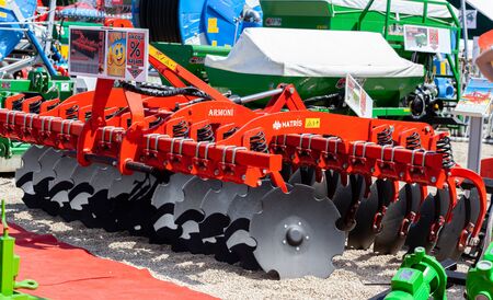Novi Sad, Serbia: may 9. 2015 - Novi Sad Agro fair with people and Fair show. Modern tractors and harvester on display on Agricultural fairのeditorial素材