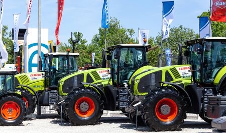 Novi Sad, Serbia: may 9. 2015 - Novi Sad Agro fair with people and Fair show. Modern tractors and harvester on display on Agricultural fairのeditorial素材