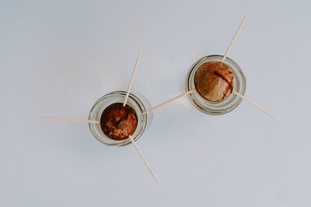 Cultivating avocado seeds at home growing in a glass of water isolated on white. photo taken from the top.の写真素材