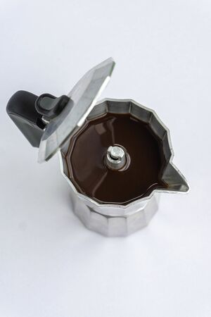Metal coffee maker machine full of coffee. Italian coffee machine isolated on white.の写真素材