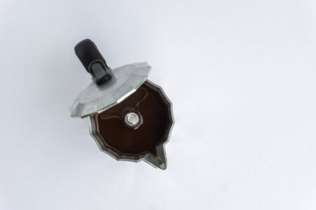 Metal coffee maker machine full of coffee. Italian coffee machine isolated on white. Top View.の写真素材
