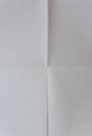 Whit paper texture. White paper sheet texture folded in four. White paper sheet folded in vertical and horizontal half. Backgroundの写真素材