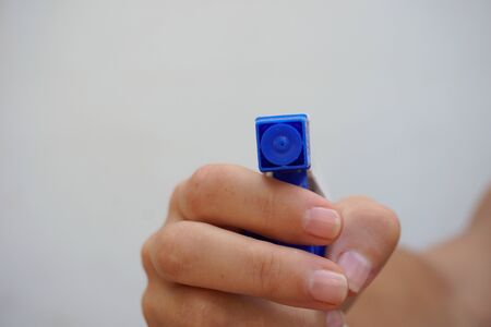Hand holding a disinfectant sprayer bottle isolated on white with spray in front of the camera. Close up view. Cleaning covid and disinfectant concept.の写真素材