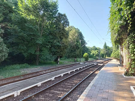 Railway platform alongside a railway trackの写真素材