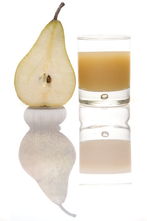 half pear with glass of juiceの写真素材
