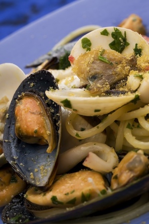 spaghetti with seafood on blue dishの写真素材
