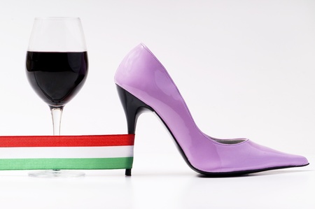 italian woman's shoe and red wine with italy flagの写真素材