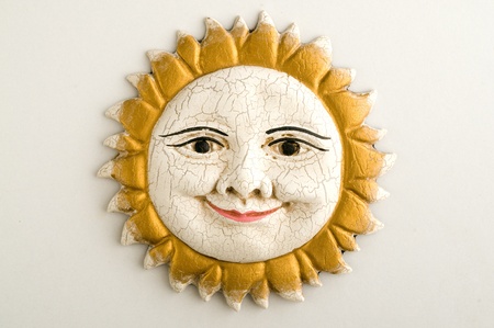 handmade ornamental sun face with rays made by terracotta の写真素材