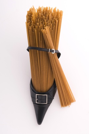 wholegrain spaghetti and woman shoeの写真素材