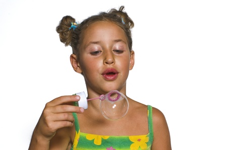 young girl blowing bubblesの写真素材