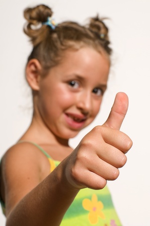 girl showing ok thumb for approvalの写真素材