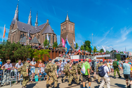 Nijmegen July 20 2017: 4Day Walking tournament contestants passing the church of the Village Cuijkのeditorial素材