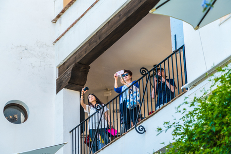 Mijas, Spain, June 28 2017: Chinese tourists making pictures from a balcony at the White town of Fijas in the south of Spainのeditorial素材
