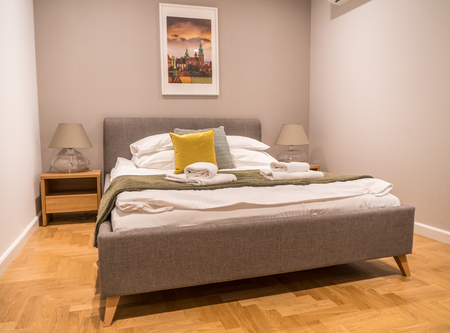 Modern hotelroom queensize bed on wooden floorのeditorial素材