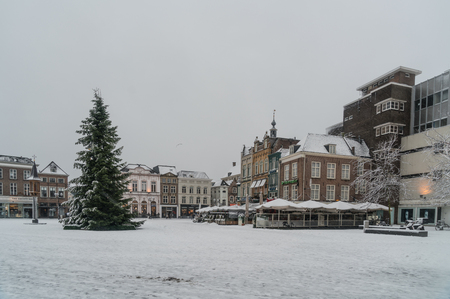 Den Bosch, The Netherlands, December 10th 2017: People crossing the snow covered Markt with in the center a christmas tree in the center of Den Bosch.のeditorial素材