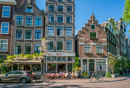 Amsterdam, May 7 2018 - locals and tourists enjoying a drink at a terrace on the Noordermakrt in the old part of townのeditorial素材