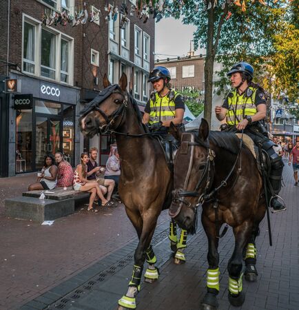Nijmegen, The Netherlands 16th July 2018 - Two mounted police officers in the city centerのeditorial素材