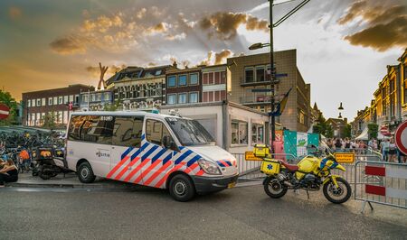 Nijmegen, The Netherlands 16th July 2018 - Police van and ambulance motorcycle parked at the entrance of the 4 days festival in Nijmegen ready to react for a emergency callのeditorial素材