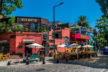 Tourists anjoying a drink on a terrace at a restaurant on a streetcorner of Recoleta, Buenos Aires,...