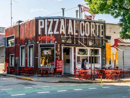 Tourists anjoying a drink on a terrace at Pizza al Corte on a streetcorner of Recoleta, Buenos Aires, Argentina - January 23th 2019のeditorial素材