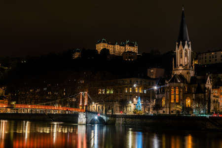Lyon, France 3rd January 2020 - People srossing the Saone River on the Passarelle St. Georges (gangway Saint George) bridge at nightのeditorial素材