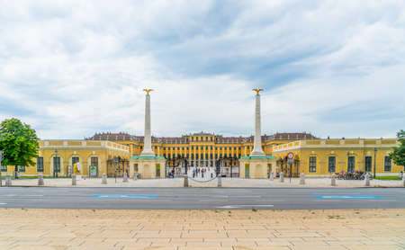 Vienna, Austria - June 25th 2020 - Exterior of the front of Schloss Schonbrunn seen from outside the gates during Corona time on a sunny day with some tourists visiting the palaceのeditorial素材