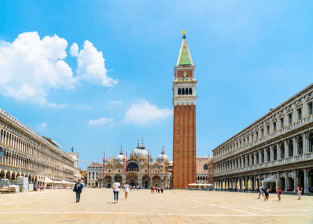 Venice, Italy - June 29th 2020 - very little tourists crossing the San Marco square with the St Mark's Campanile tower (Loggetta del Sansovino) and the Saint Mark's Basilica (Basilica di San Marco) on a sunny Corona day in summerのeditorial素材