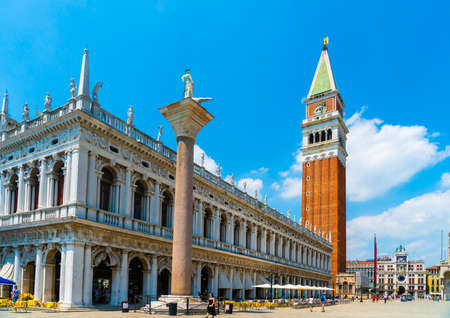 Venice, Italy - June 29th 2020 - very little tourists crossing the San Marco square with the St Mark's Campanile tower (Loggetta del Sansovino) on a sunny Corona day in summerのeditorial素材