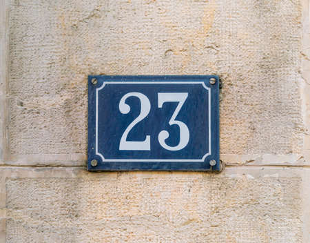 House number 10 seperate metal numbers on a old limestone wall of a authentic Franch houseの写真素材