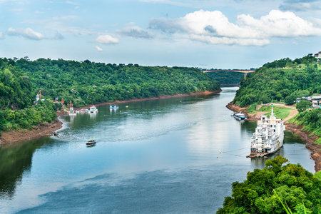 Tourists boat sailing on the Iguazu river seen seen from the Argentinian side, Iguazu, Brazil, February 3th 2019の写真素材