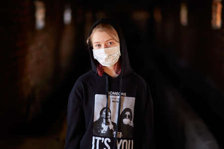 Donetsk / Russia / March 3, 2020, little girl in medical mask during quarantine in a ruined buildingのeditorial素材