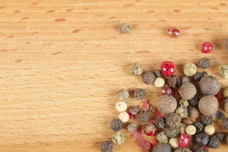 mixture of peppers hot pepper, red pepper, black pepper, white pepper, green pepper, background