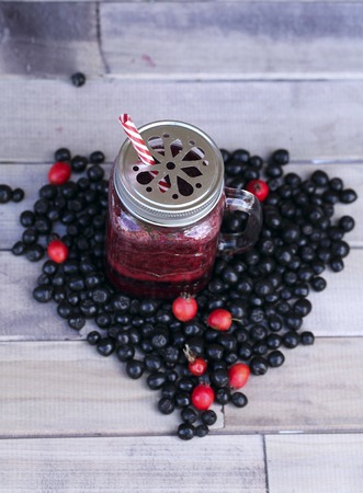 Berry smoothie on a old wooden background. Heart shapeの写真素材