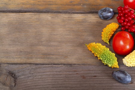 Fruit background. Fresh organic fruit, vegetable and berry on old wood. Autumn harvestの写真素材
