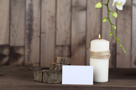 Orchid , candle , cinnamon, paper and stumps on wood backgroundの写真素材