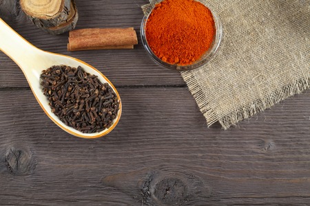 Herbs and Spices over wooden background. Pile cloves on wood backgroundの写真素材