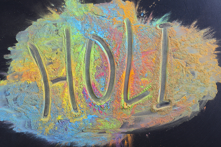 Celebrate festival Holi. Indian Holi festival colours. Letter Holi on black backgroundの写真素材