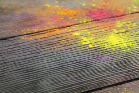 Holi colours on woodの写真素材